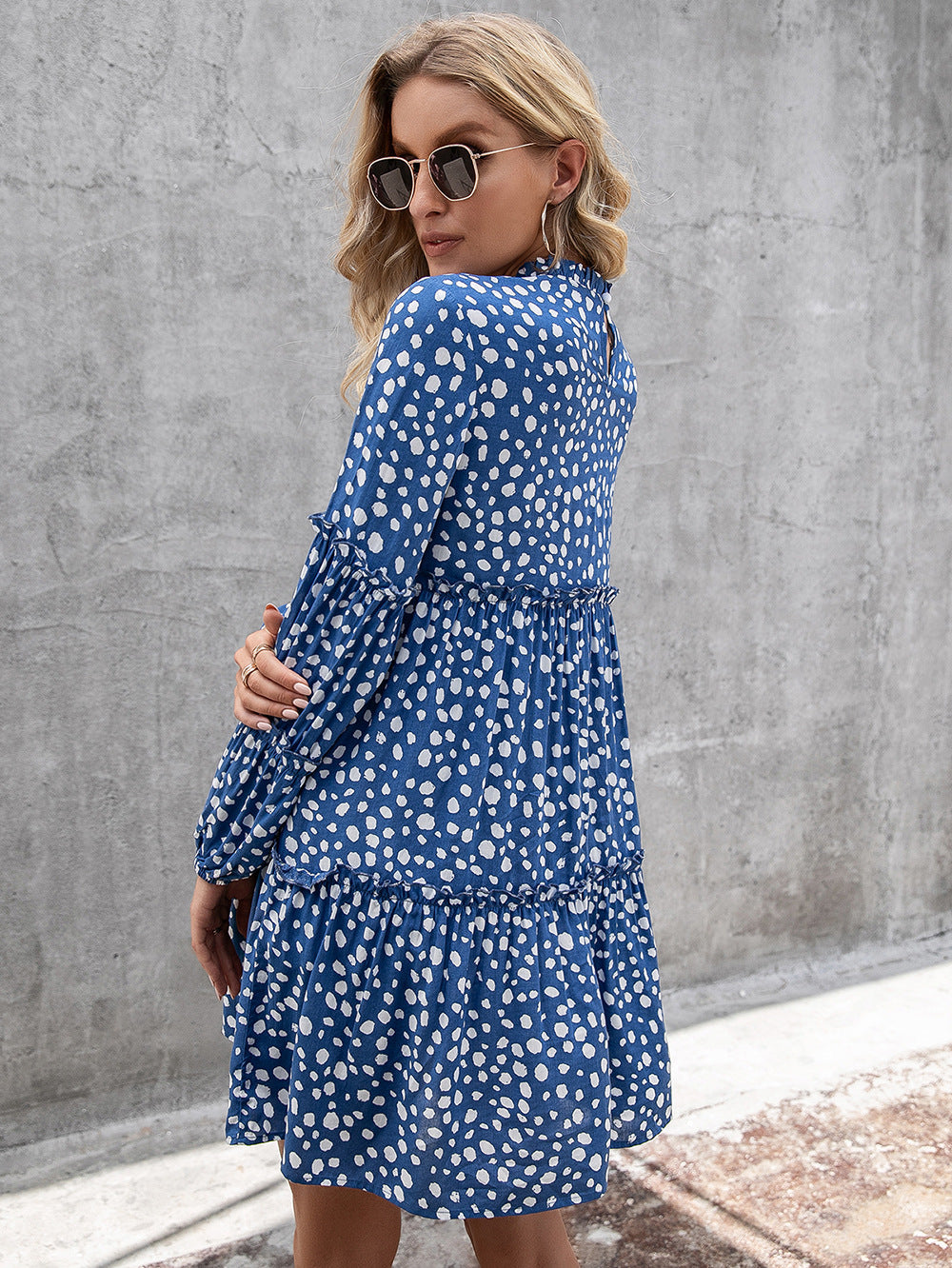 Cerulean polka dot mini dress with ruffle yoke and tiered skirt.
