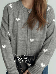 Gray zip-through knit sweater with allover white heart print and crew neck.