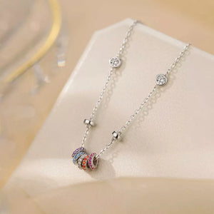 Silver necklace with bezel-set cubic zirconia and colorful zircon cluster rings.