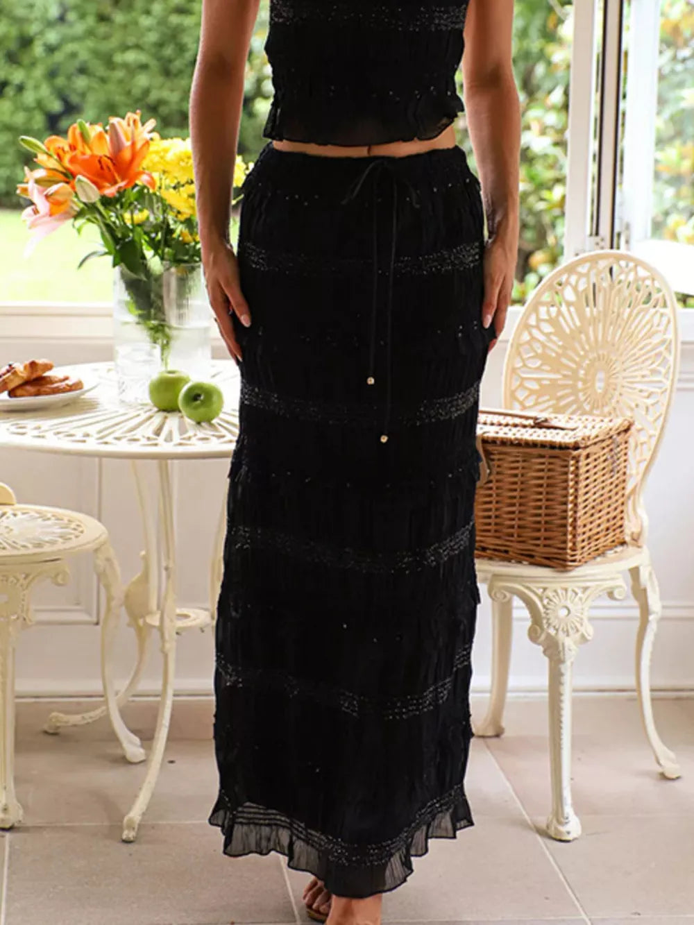 Black smocked maxi skirt with tiered ruffle hem and drawstring waist
