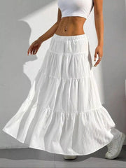 White tiered maxi skirt with elastic waistband and textured fabric.