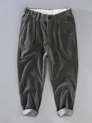 Smoky gray corduroy pleated casual pants with elastic waistband and cuffed hem.