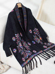 Black Aztec fringe knit cardigan with colorful geometric pattern and fringed hem.