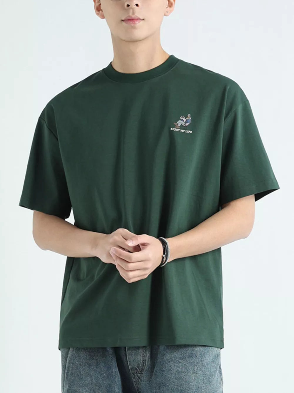 Men's dark green cotton graphic tee with embroidered detail and text.