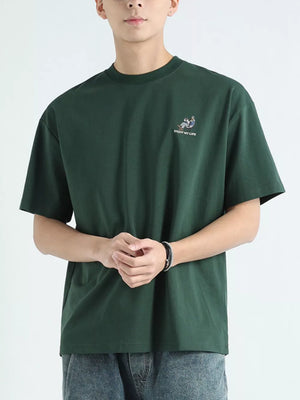 Men's dark green cotton graphic tee with embroidered detail and text.