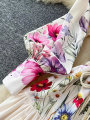 Vibrant floral midi dress with lantern sleeves and button detail, featuring a brocade fabric.