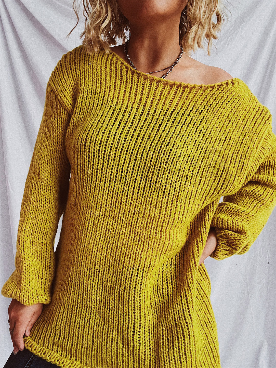 Mustard open-knit slouchy boatneck pullover sweater with long sleeves.