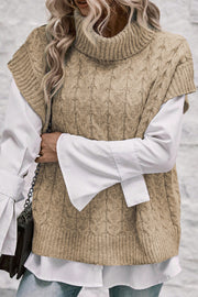Khaki cable knit turtleneck capelet sweater styled with a white shirt.