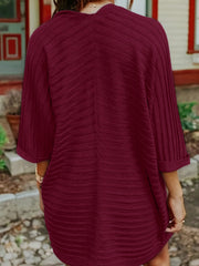 Burgundy ribbed sleeve cardigan with textured fabric and cuffed sleeves.