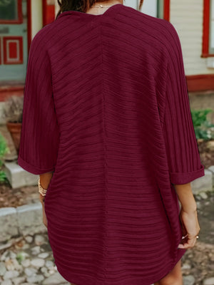 Burgundy ribbed sleeve cardigan with textured fabric and cuffed sleeves.
