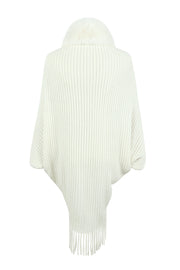 Ivory knit cape with faux fur collar and fringe detail