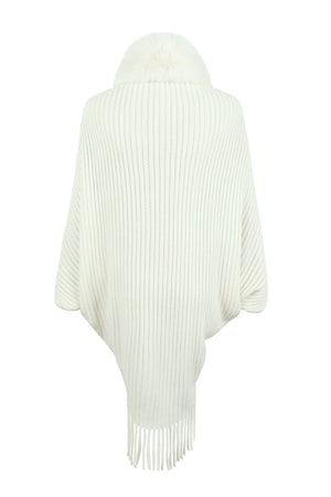 Ivory knit cape with faux fur collar and fringe detail
