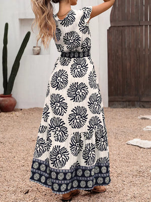 Botanical print maxi dress with cap sleeves, V-neck, and border print detail.