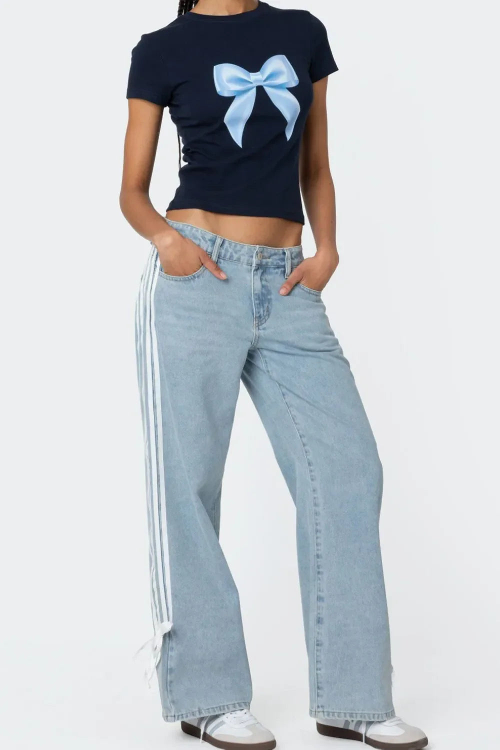 Light blue denim wide-leg trousers with white side stripes and tie detail at hem.