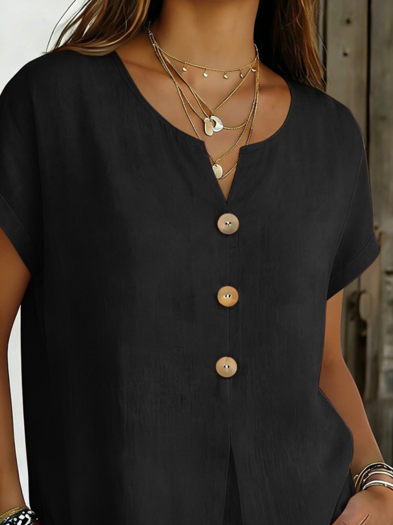 Black buttoned short sleeve blouse with V-neck and wooden buttons