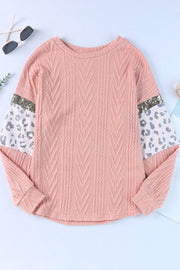 Pale blush sweater with textured chevron body and leopard print sleeves with sequin trim.