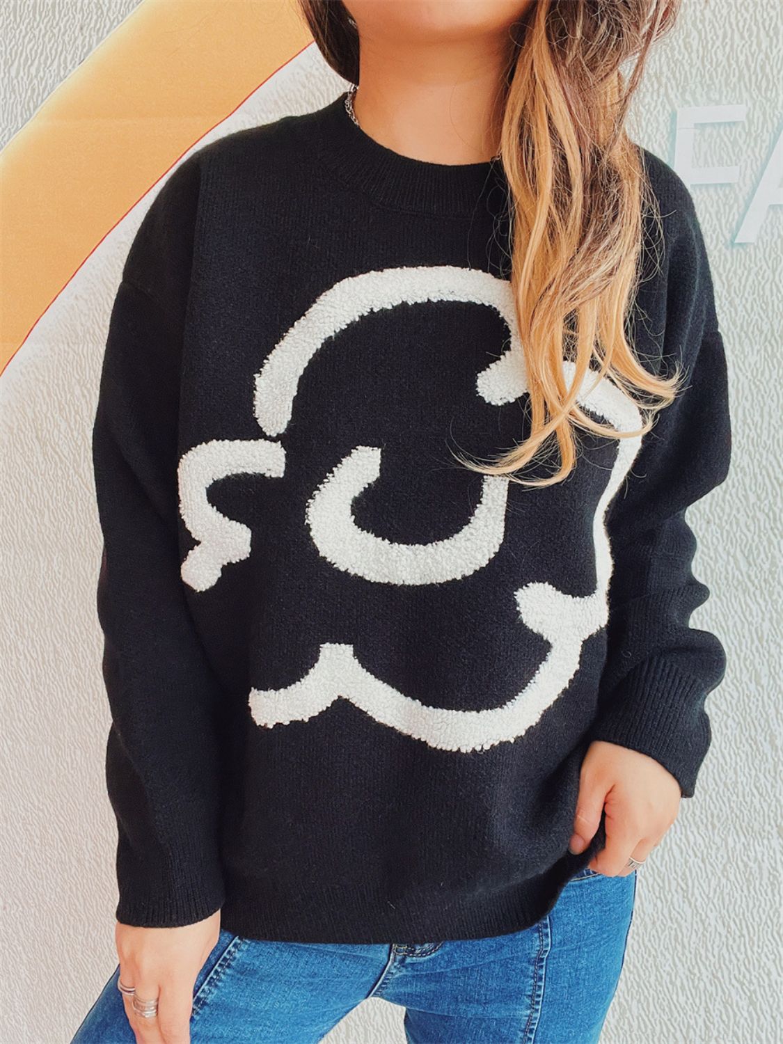 Black acrylic sweater with white cloud intarsia knit pattern, crew neck, long sleeves.