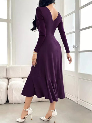 Purple midi dress with long sleeves, V-neck, ruffled hem, and slit.