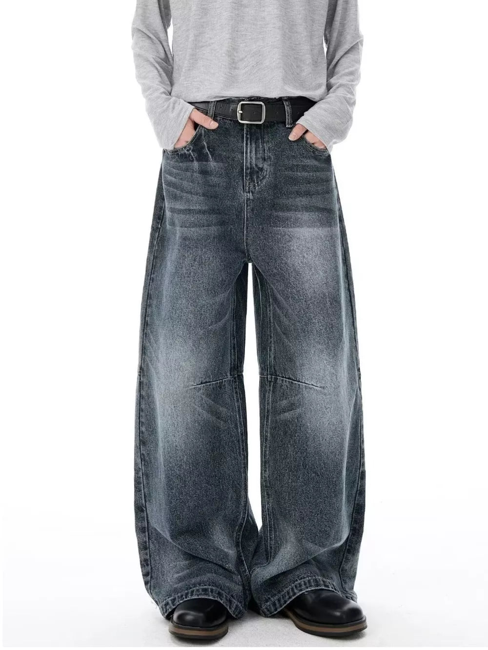 Men's vintage-inspired wide-leg jeans in dark wash denim with a black belt.