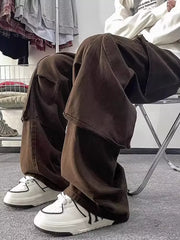 Brown cargo pants with ample pockets, loose fit, worn with white sneakers.