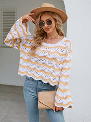Scalloped crochet crop sweater in white with yellow wavy stripes, bell sleeves, and open knit detail.