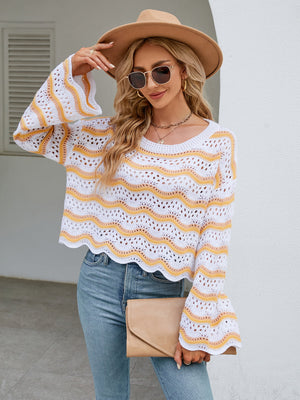 Scalloped crochet crop sweater in white with yellow wavy stripes, bell sleeves, and open knit detail.