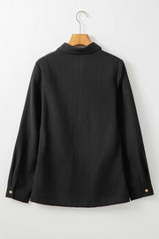 Black textured ribbed button-down shirt with long sleeves and button cuffs.