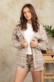 Camel plaid shacket with sherpa hood and buttoned front, styled with a white top and beige shorts.