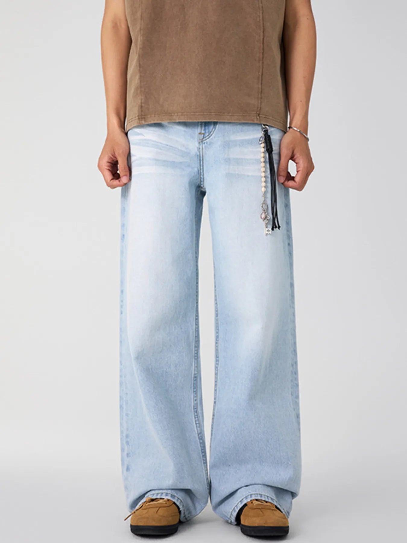 Washed wide-leg men's jeans in Glacier Blue with a beaded keychain detail.