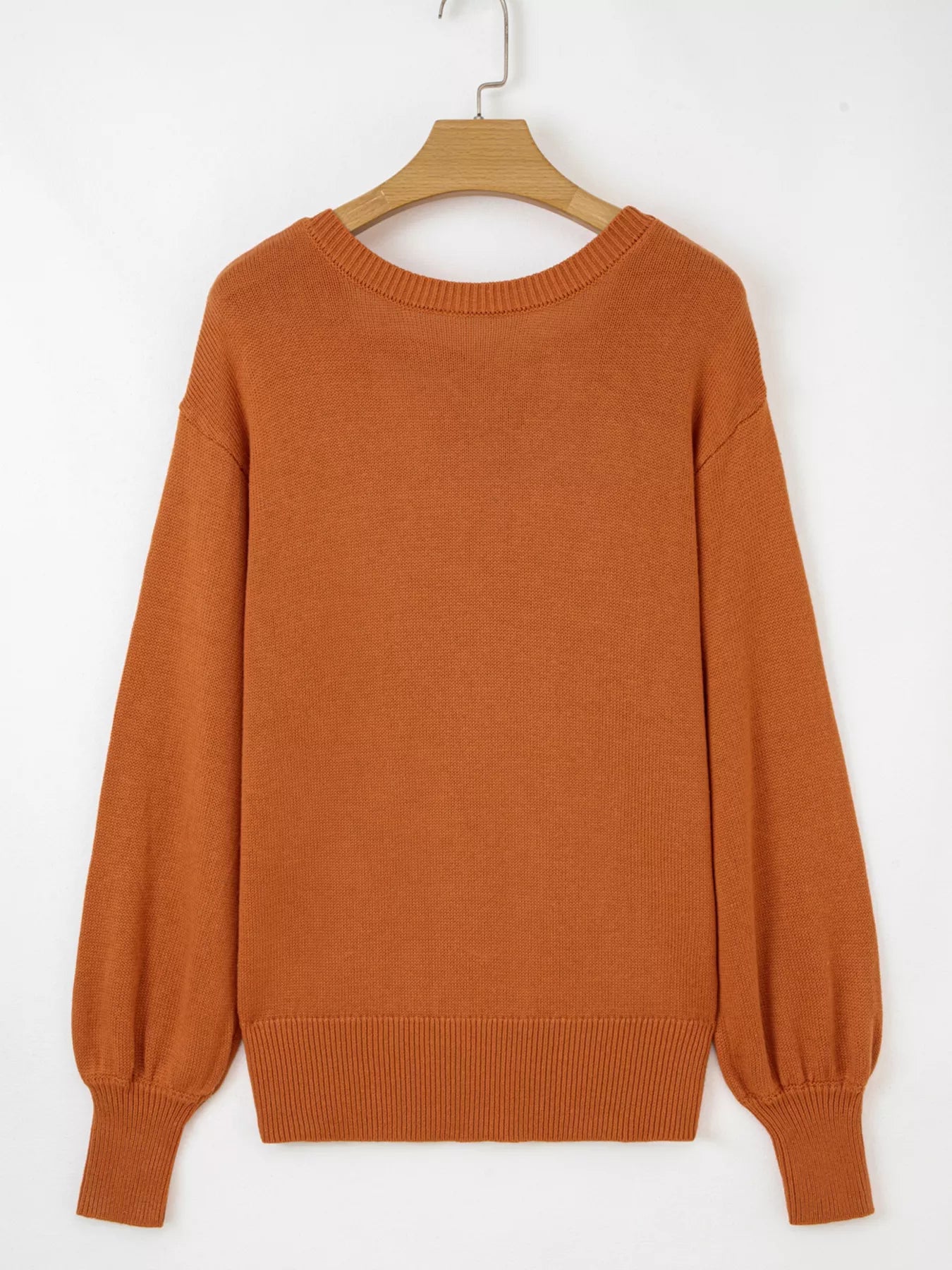 Caramel acrylic blend drop shoulder sweater with balloon sleeves and ribbed cuffs.