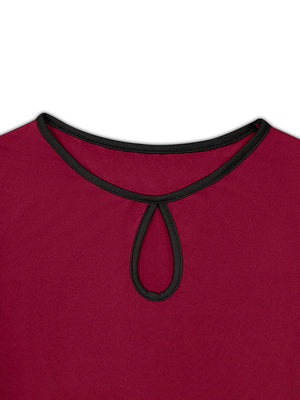 Burgundy peplum blouse with keyhole neckline and black trim.