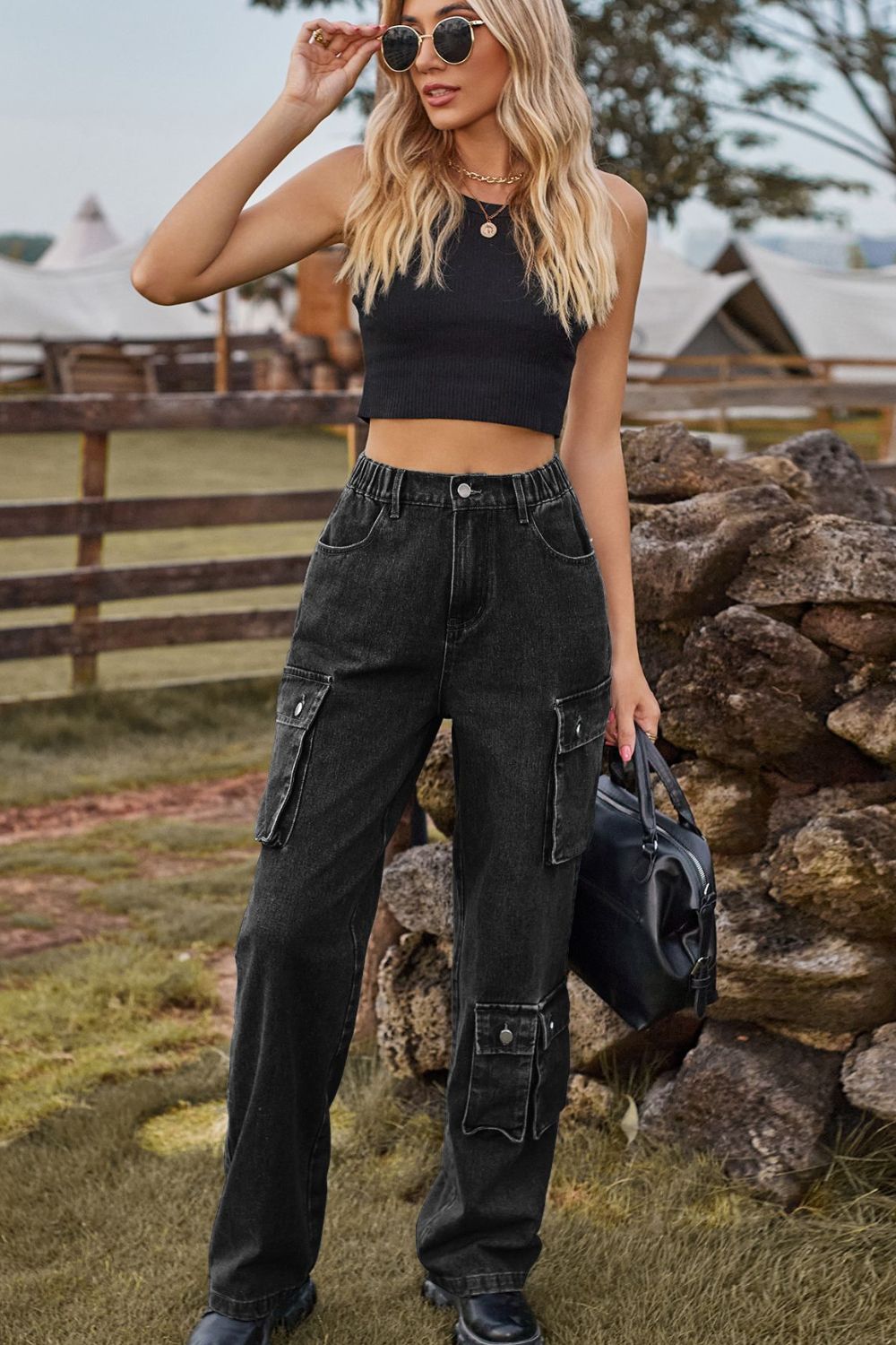Black denim cargo pants with relaxed wide leg and utility pockets.
