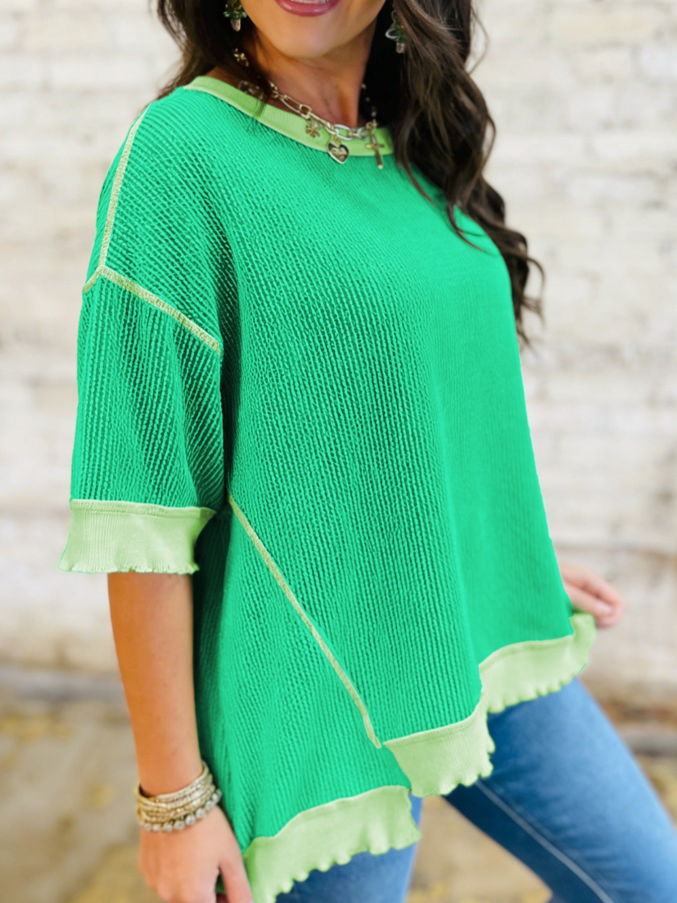 Bright green ribbed t-shirt with contrast stitching and asymmetrical hem.