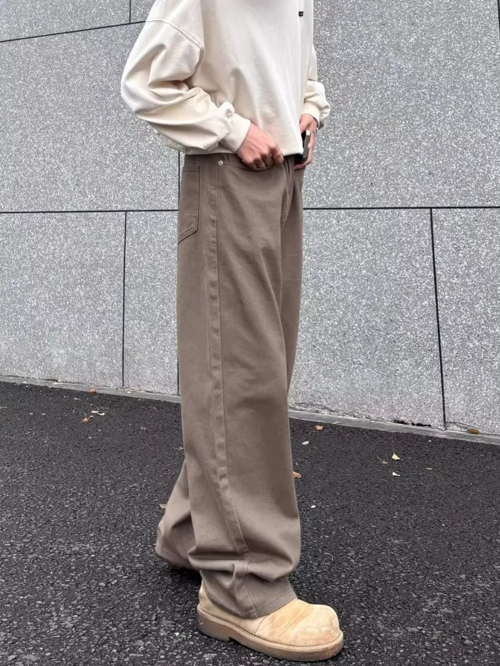 Men's brown wide-leg sweatpants with a relaxed fit and casual styling.