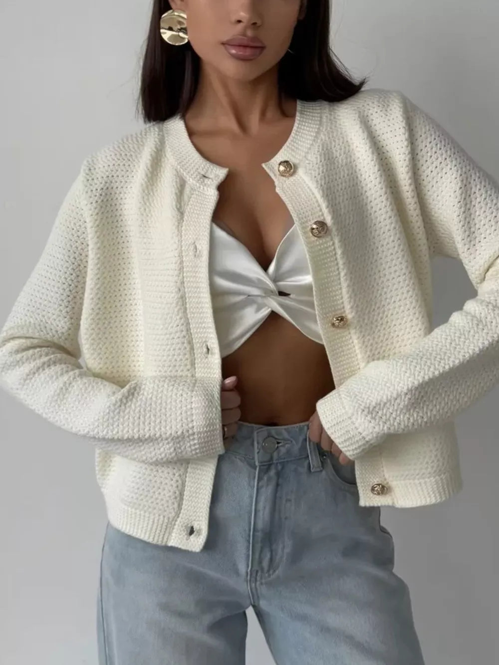 Textured knit white cardigan with gold button detail and crew neck.