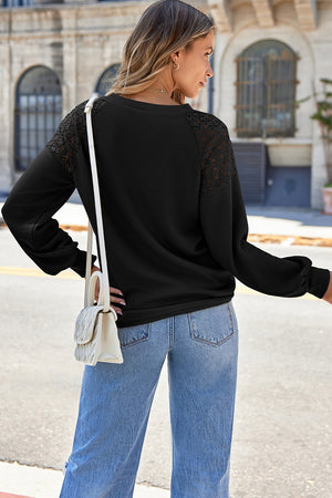 Black waffle knit raglan top with lace yoke detail and balloon sleeves.