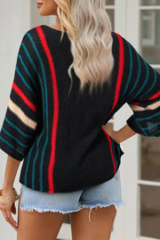 Black knit pullover with red, teal, and cream stripe details on sleeves and back.