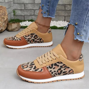 Leopard print panel runner sneakers with tan and brown accents and white soles.