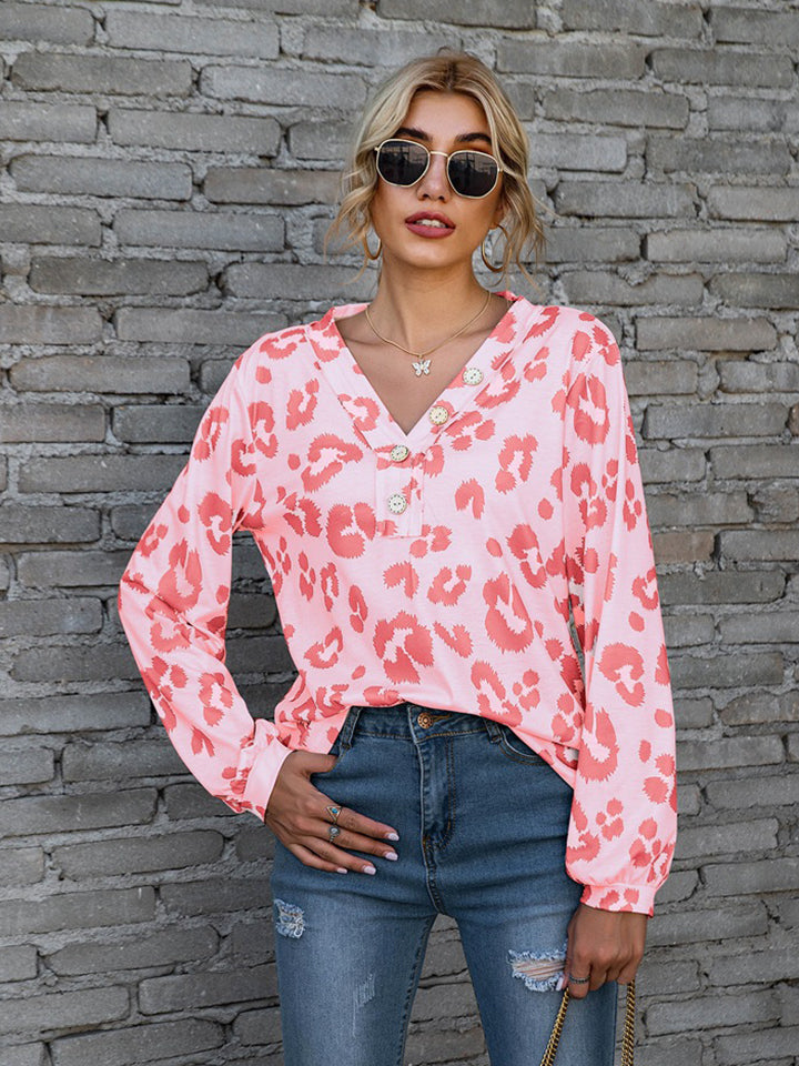 Pink leopard print henley blouse with blouson sleeves and button detail