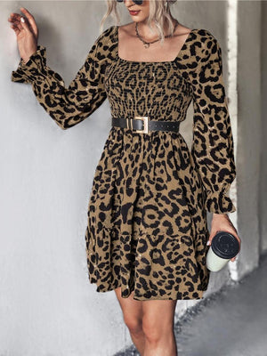 Smocked bodice leopard print mini dress with square neck, long puff sleeves, and tiered skirt.