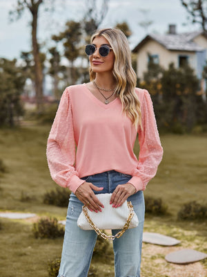 Pink Swiss dot sleeve v-neck blouse with long puff sleeves.