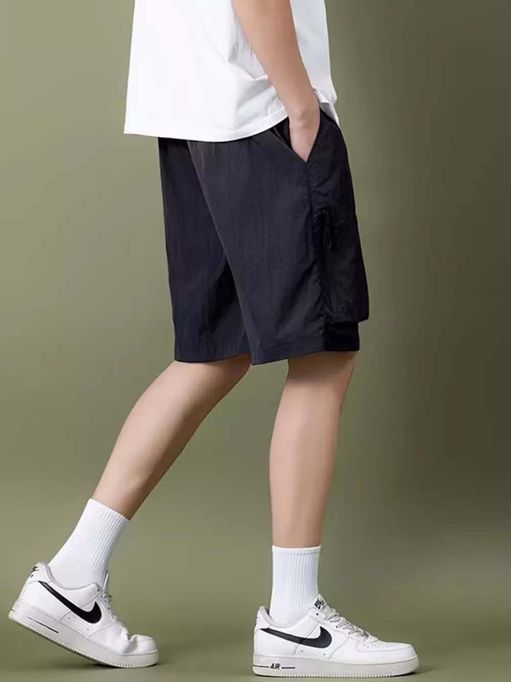 Black lightweight cargo shorts with zipper pocket detail and drawstring waist