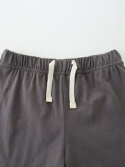 Baby shorts with elastic waistband and drawstring detail in dark grey cotton.