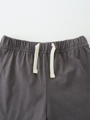 Baby shorts with elastic waistband and drawstring detail in dark grey cotton.