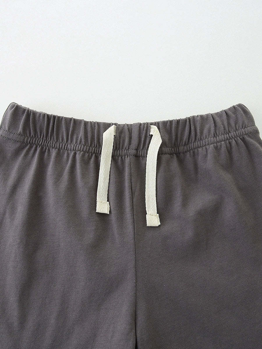 Baby shorts with elastic waistband and drawstring detail in dark grey cotton.