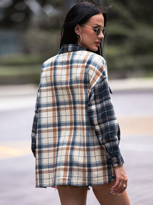 Colorblock plaid utility shacket in navy with a relaxed fit and button cuffs.
