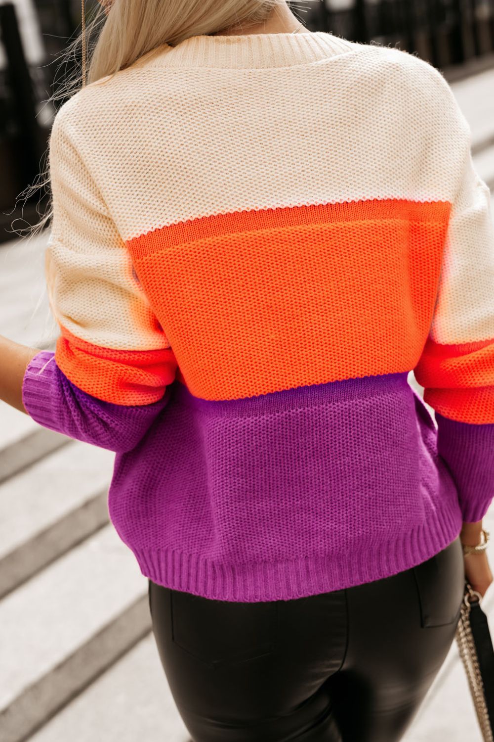 Colorblock ribbed knit pullover sweater in cream, orange, and purple acrylic.