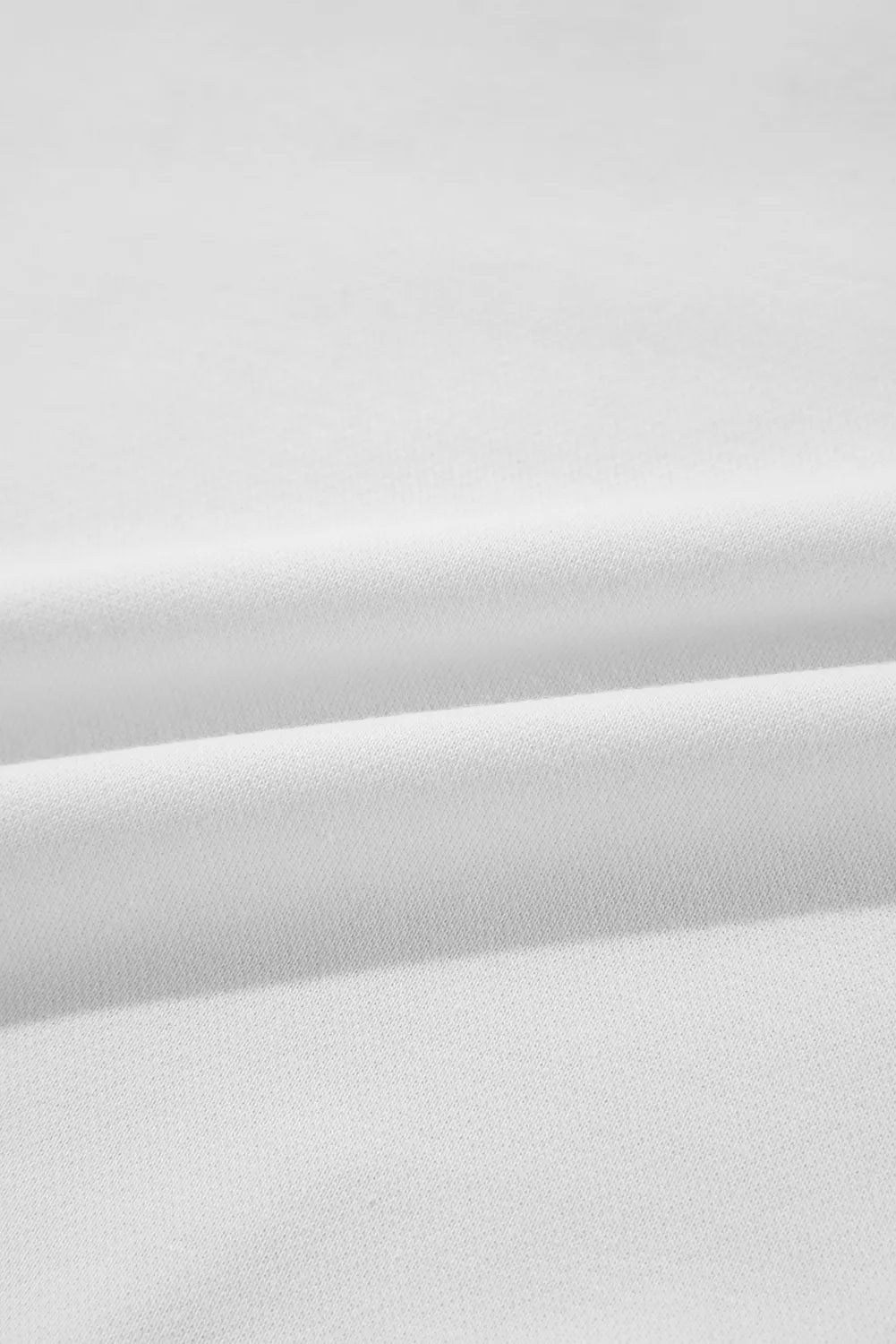 White sweatshirt fabric detail, soft knit texture, comfortable casual wear