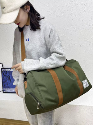 Green Oxford cloth duffel bag with brown straps and a side zip pocket.