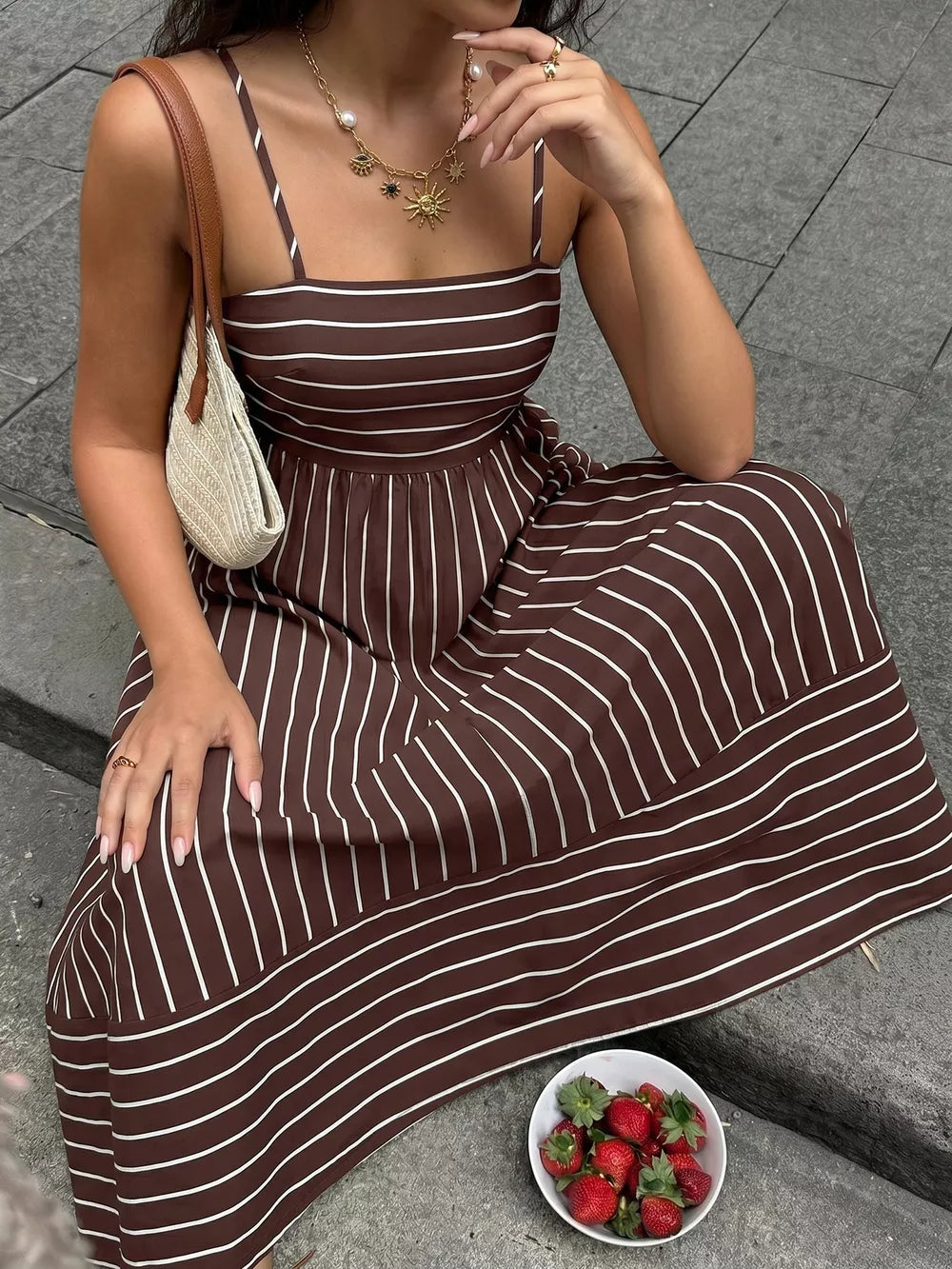 Brown striped maxi dress with smocked detail and cutout, square neck, spaghetti straps.
